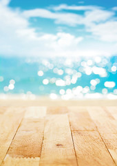Wood table top on blur summer beach and sunny sky background