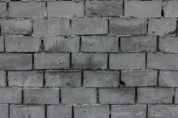 The old brick and stone wall with plaster
