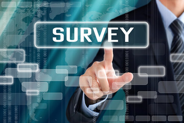 Businessman hand touching SURVEY button on virtual screen