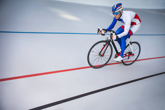 Racing Cyclist On Velodrome Outdoor.