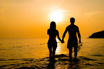 Silhouette of couple at the beach in sunset