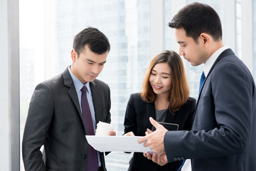 Business people discussing work at building hallway