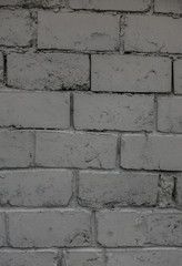 The old brick and stone wall with plaster