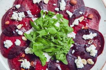 Fresh green salad with beets, goat cheese and olive oil, healthy food, organic.