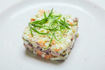 Russian traditional salad olivier with pea.