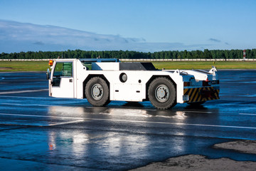 Airplane tow tractor at the airport apron