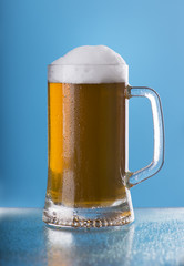Light beer mug against the backdrop of the bar shelf
