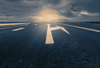 Arrow signs as road markings on a desert road