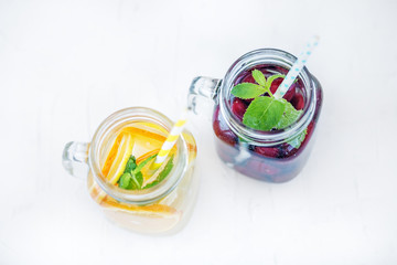 Fruit cocktail with cherries. Detox water with lemon, orange and mint. Top view.The concept is summer, diet, vegetarian, fitness, healthy eating and lifestyle.
