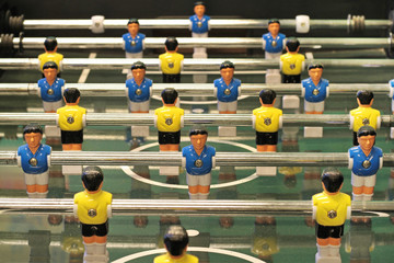 Foosball, Table football game or Table Soccer with yellow and blue players