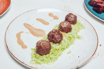 Meat balls in sauce with boiled rice.
