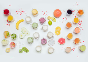 Fresh juices, smoothies and smoothies on a white table.