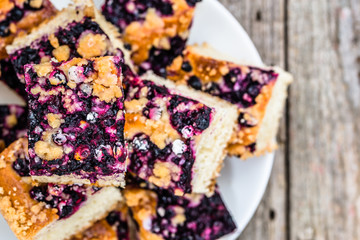 Sweet cake with blueberry fruits on yeast pastry, summer baking concept, overhead