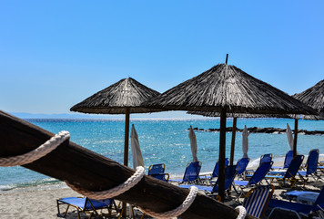 Sunbeds and umbrellas on the beach against a bright turquoise sea