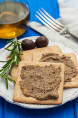 pate with toasts on white plate