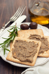 pate with toasts on white plate