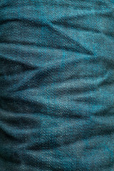 Wrinkled of indigo denim jeans texture background. close up dark blue denim pants texture fashion style.