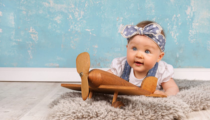 mit dem Holzflieger spielen, lachendes Baby