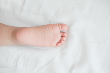 Baby foot on white sheets