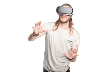 young man gesturing while using virtual reality headset, isolated on white