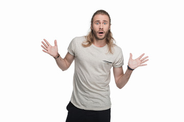 Fototapeta premium shocked young man looking at camera, isolated on white