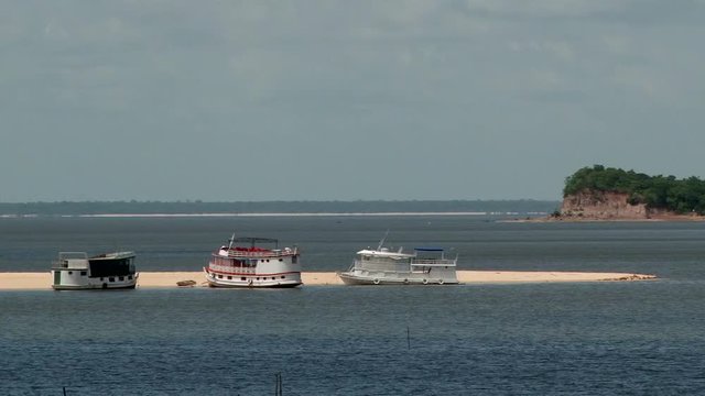 Traditional river boats are aground on sandy shore at Alter do Chao, Para, Brazil