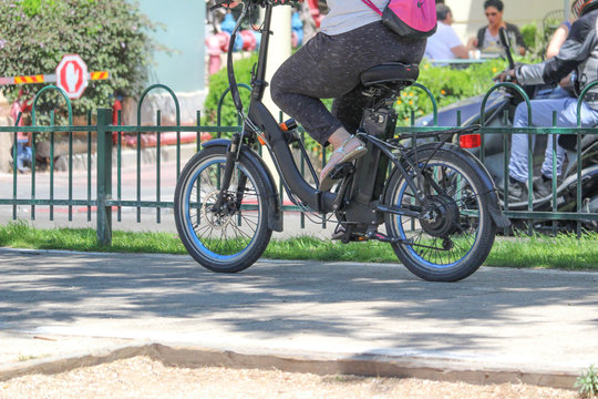 A women riding an electric bicycle in the city