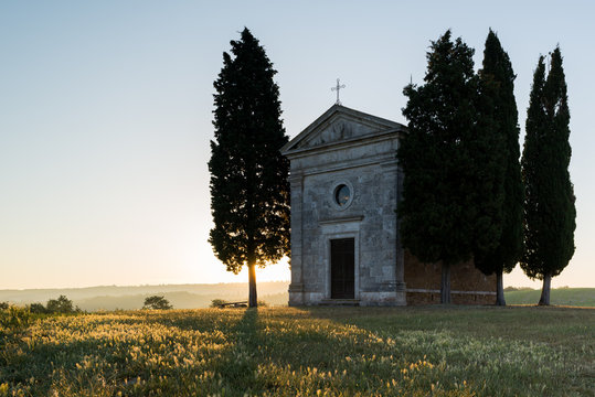 Vitaleta chapel small churt in Tuscany Val d'Orcia in Italy at sunrise in summer