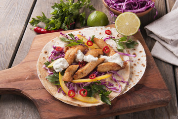 Chicken fajitas vegetables and sauce on a Mexican tortilla tacos