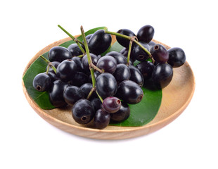 Jambolan plum in wood plate isolated on white background