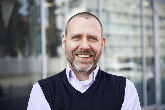 Smiling Man In Front Of The Building