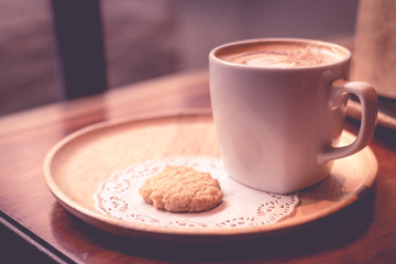 Cappuccino on wood texture.