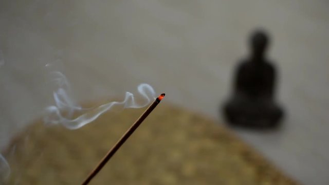 Smoking incense buddha statue