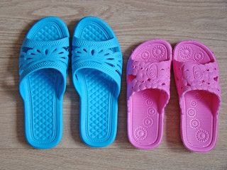 Two pairs of rubber slippers on the floor