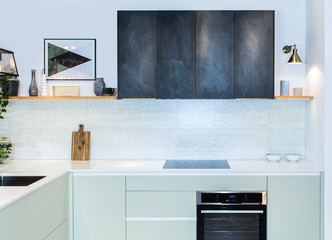 Modern kitchen design in home interior. Facades are painted and made of natural stone. Project management. Loft Light Fixture Lights in Black Metal Frame Shade with Clear Panel Glass. Copper Wire.