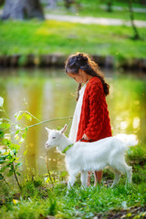 A little girl the shepherd led his goatling to the lake, so that he would drink water