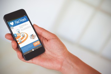 Composite 3d image of womans hand holding black smartphone