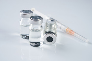 Medical ampoules, infusion and syringe with injection isolated on white background with copy space....