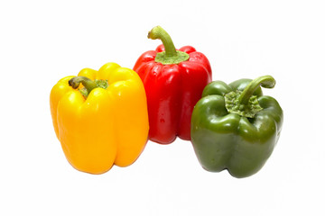 Colored bell peppers on white background