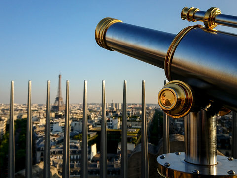 Monocular telescope and panoramic views of Paris in a sunny day with Eiffel Tower