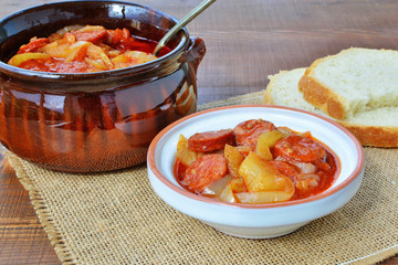 Vegetable stew, lecho in bowl and ceramic pot