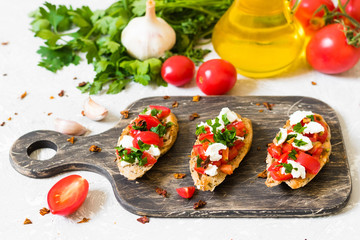Bruschetta with tomatoes and curd cheese on whole wheat bread