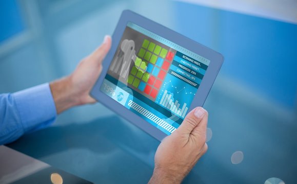 Composite 3d image of businessman using his tablet 