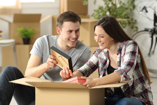 Couple packing while moving house