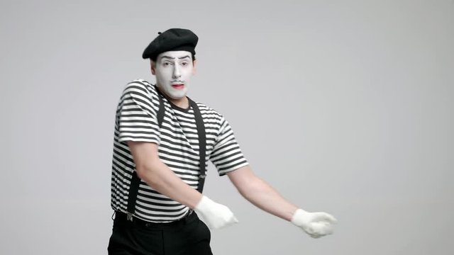 Mime artist pulling an invisible rope