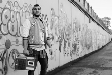 Black and white photo of a man dressed in hip hop style