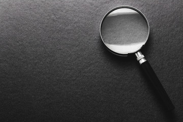 magnifying glass on  black texture  background. - 161861076