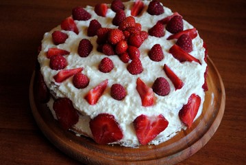 Homemade cream layer cake, fresh, colorful, and delicious dessert with juicy strawberries, sweet whipped cream and cream cheese