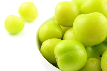 fresh turkish can erik plum fruits in a small white bowl