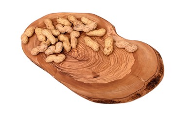 Peanuts in a shell on a wooden board isolated on a white background
